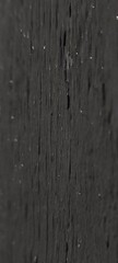 Close-up of a textured black wooden surface with visible grain patterns and small imperfections. Ideal for backgrounds or design elements.