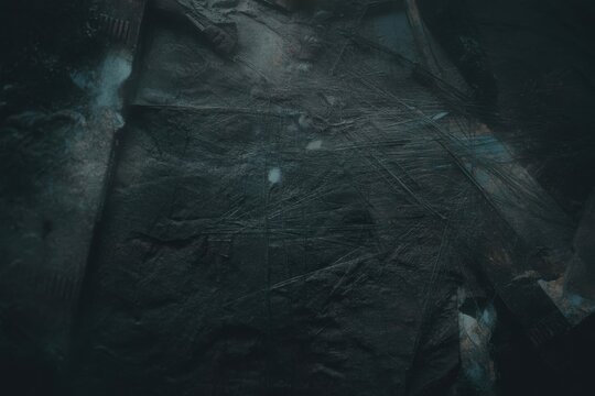 Abstract dark rock surface with scratches and grunge textures pattern