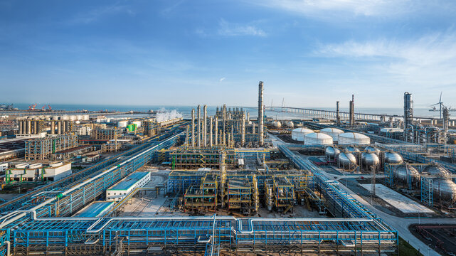 Aerial panoramic view of a massive coastal oil refinery and petrochemical industrial complex. - Powered by Adobe