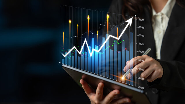 A businesswoman analyzes financial data using a tablet in a modern office while showcasing an upward growth chart. Digital overlays highlight performance trends. Scalp