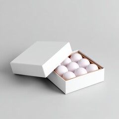 A minimalist box opened to reveal several white eggs arranged neatly inside, set against a light gray background.