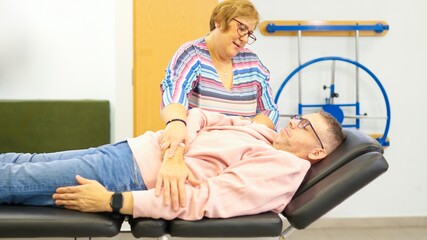 Physiotherapist working on patient arm during treatment session