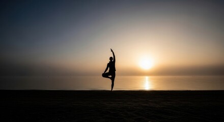 Silhouette of woman in tree pose on beach at sunrise. Harmony and wellness concept.
