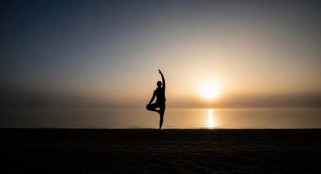 Silhouette of woman in tree pose on beach at sunrise. Harmony and wellness concept.