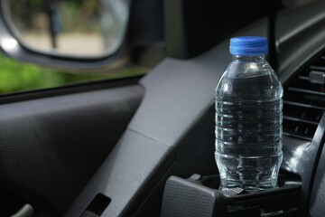 Drinking water in the car prepared for traveling