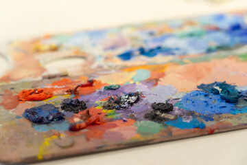 Artist palette showing vivid colors of oil paint