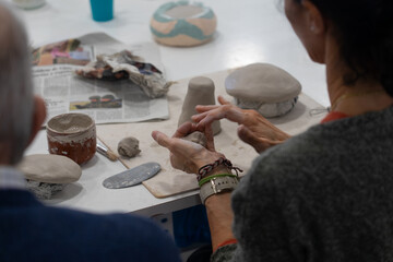 Hands modeling clay shaping pottery in workshop