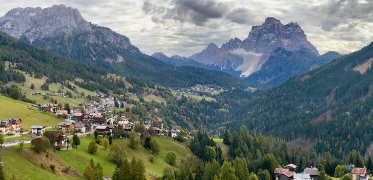Alpine village Selva di Cadore in green valley with beautiful mountains view, South Tyrol, Dolomiti Mountains, Italy 
