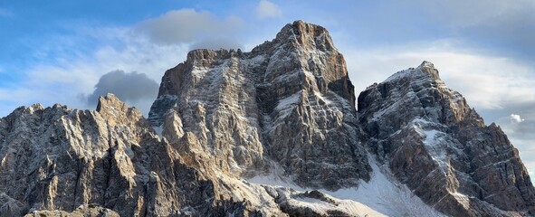 Naklejka premium Monte Pelmo in the Dolomites striking destination for photography. Known for its massive rock formation and unique profile, it offers rugged peaks, alpine views, and dramatic mountain scenery 