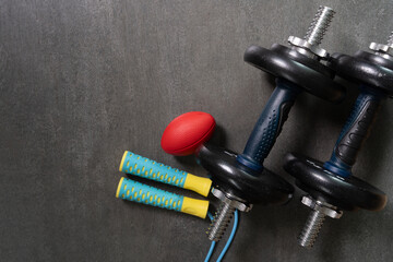 Time for exercising sport equipment on the black table background, healthy and workout concept