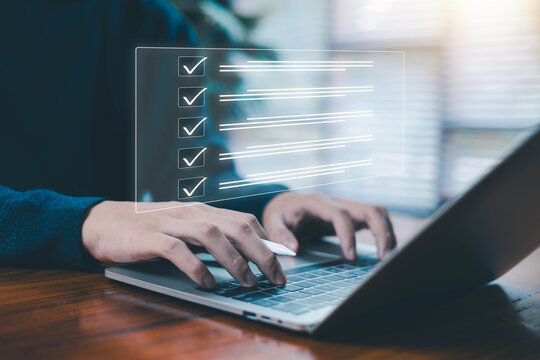 Hands typing on laptop with glowing digital checklist interface symbolizing task management, productivity workflow project planning, and modern digital organization tools for efficient work processes.