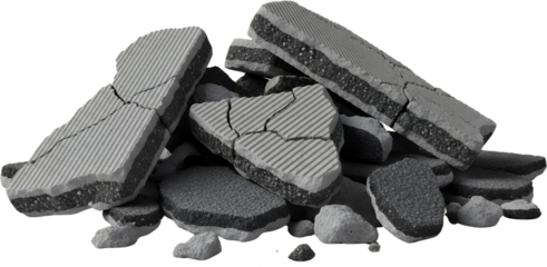 Pile of broken asphalt road pieces showing grey concrete top layer with lines and black tar bottom layer debris construction