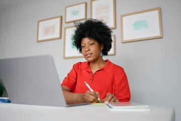 Black woman working or studying at home office
