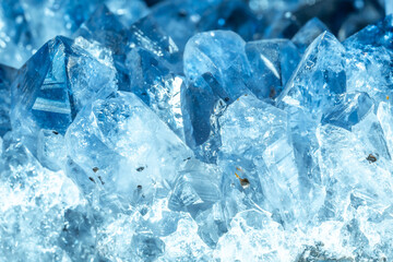 Obraz premium Blue Crystal Mineral Stone. Gems. Mineral crystals in the natural environment. Texture of precious and semiprecious stones. Seamless background with copy space colored shiny surface of precious stones