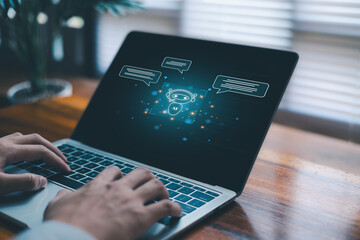 Hands typing on laptop with glowing AI chatbot interface representing modern artificial intelligence digital communication virtual assistant technology and innovative machine learning support systems.