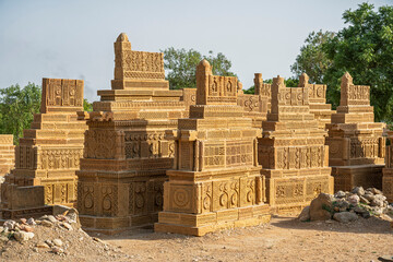 Landscape view of group of ancient carved golden sandstone islamic tombs in Chaukhandi cemetery, Karachi, Sindh, Pakistan