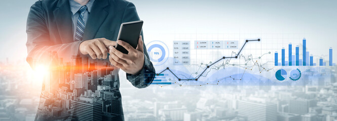 A business professional using a tablet to analyze data trends in an urban environment. Digital graphs and charts illustrate financial growth and market performance. Scalp
