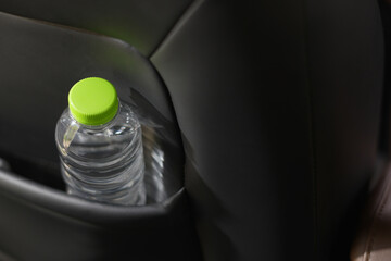 Drinking water in the car prepared for traveling