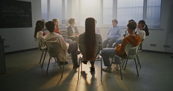 Diverse Group of Students Participates in Classroom Talk on Mental Health Guided by Compassionate Teacher. Concept Empathy, Open Communication, and Psychological Safety in Education. Slow Motion.