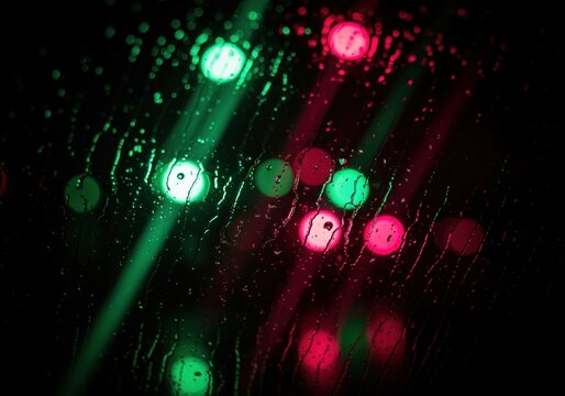 Rainy night abstract background with intense green and crimson bokeh lights