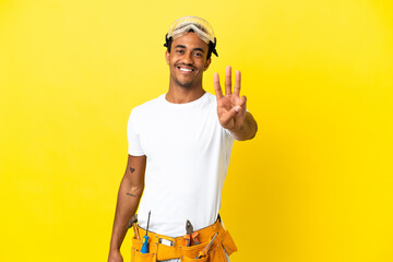 African American electrician man over isolated yellow wall happy and counting three with fingers