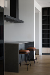 Modern kitchen with marble island and leather bar stools