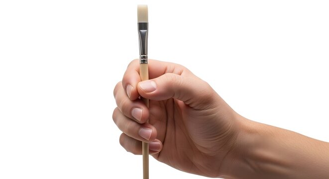 Hand holding a paintbrush with a wooden handle and white bristles against a white background.