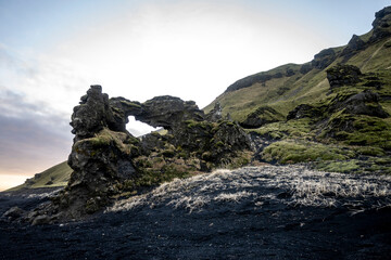 Icelandic landscape with a basaltic rock in the foreground