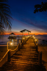 Fototapeta premium Tranquil sunset over serene Koh Kood Island pier in Thailands azure waters