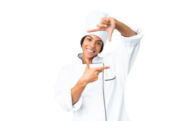 Young African American chef over isolated chroma key background focusing face. Framing symbol