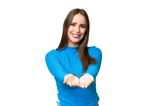Young beautiful woman over isolated chroma key background holding copyspace imaginary on the palm to insert an ad