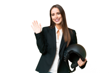 Young Asian woman with a motorcycle helmet over isolated chroma key background saluting with hand with happy expression