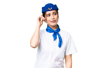 Airplane stewardess over isolated chroma key background having doubts and with confuse face expression