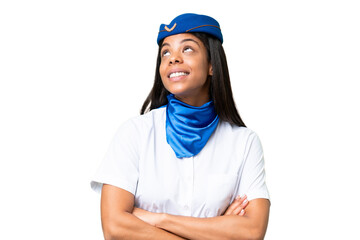 Airplane stewardess African american woman over isolated background looking up while smiling