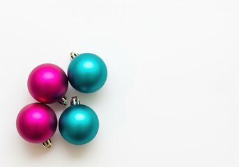Brightly colored matte magenta and electric teal holiday spherical ornaments on white