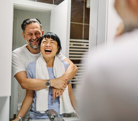 Portrait of a young couple applying cream, skincare and cosmetic,  in front of mirror in bathroom. Dental hygiene, youth, love and beauty concepts