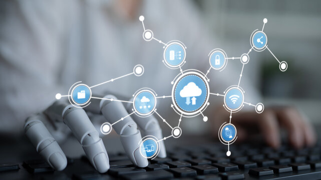 A robotic hand interacts with cloud technology in a modern workspace. The image symbolizes the connection between automation and digital data management in today world. Tessel