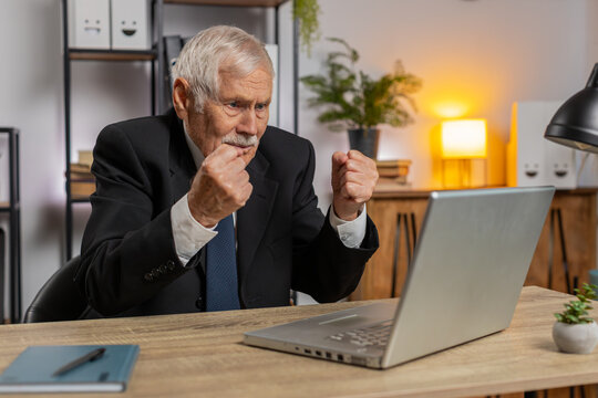 Conflict quarrel negotiation. Angry senior freelancer businessman making webcam laptop online video call at home office. Upset mad man talking conversation analyzing financial report mistake problem.