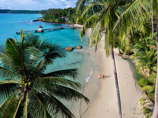 Peaceful beach stroll on Koh Kood Island in Thailand surrounded by lush palm trees