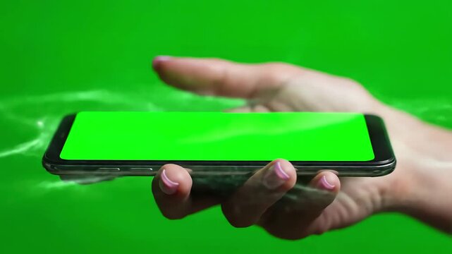 Green Screen female hand holding a smartphone with in home chroma key phone video scene 3 distortion, overlay, glitch, static noise, scan lines on black background, 4k animated loop