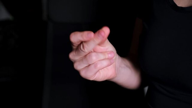 Snapping middle finger. Close-up woman hand snap finger or clicks hand isolated on black background. Sound production. Professional beat. Body music. High quality 4k footage.