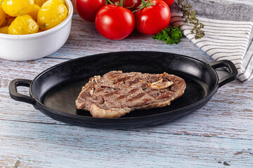 Grilled lamb steak with bone