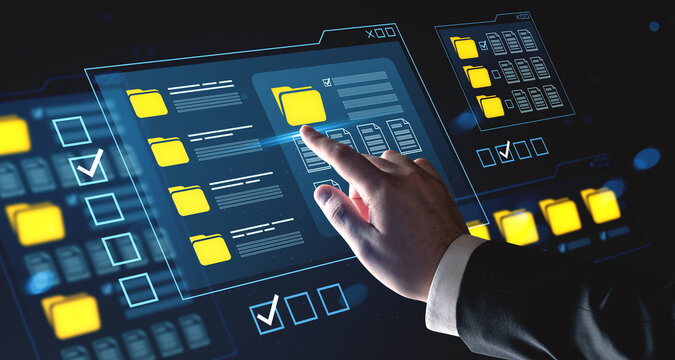 Businessman's hand interacting with futuristic digital file folder interface concept on virtual screen with glowing UI elements and transparent panels.