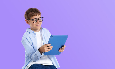 Smiling boy using digital tablet for internet search and online