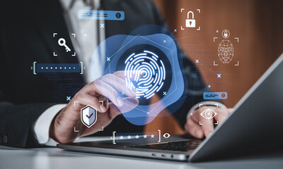 Businessman using fingerprint biometric authentication on laptop with digital security interface icons for identity verification and data protection concept.