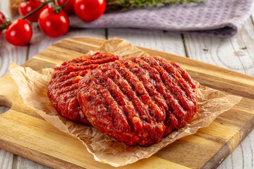 Raw uncoocked red beef round cutlet