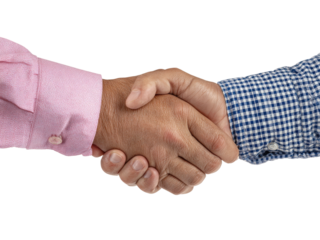 Two hands shaking in a business meeting