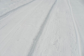 Winter Road with Tire Tracks in Fresh Snow