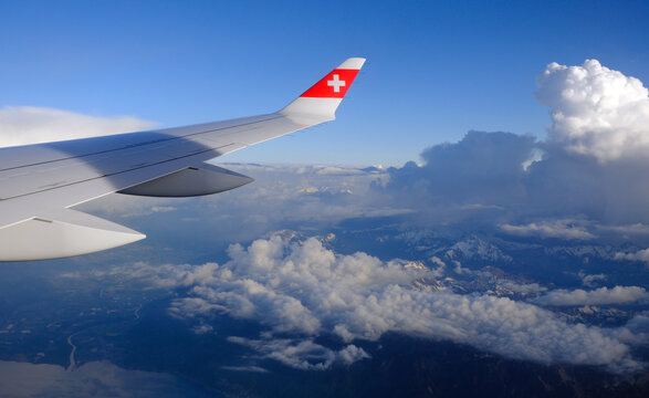 SWISS Airlines Airbus A220 wing and clouds at sunset