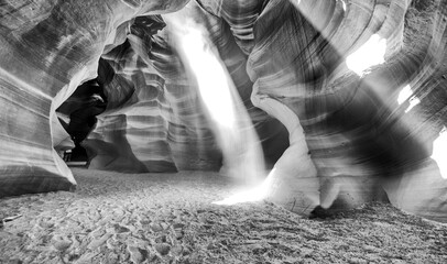 Spectacular Antelope Canyon interior with light beams illuminating red sand and sculpted rock walls